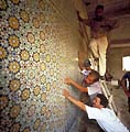 Panels of zillij tilework are mounted and aligned
